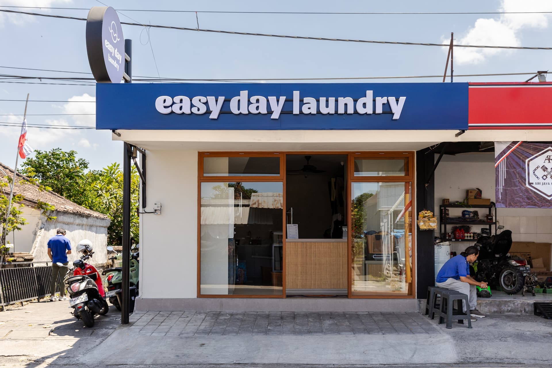 Easy Day Laundry Tumbak Bayuh storefront with blue signage and glass frontage in daylight