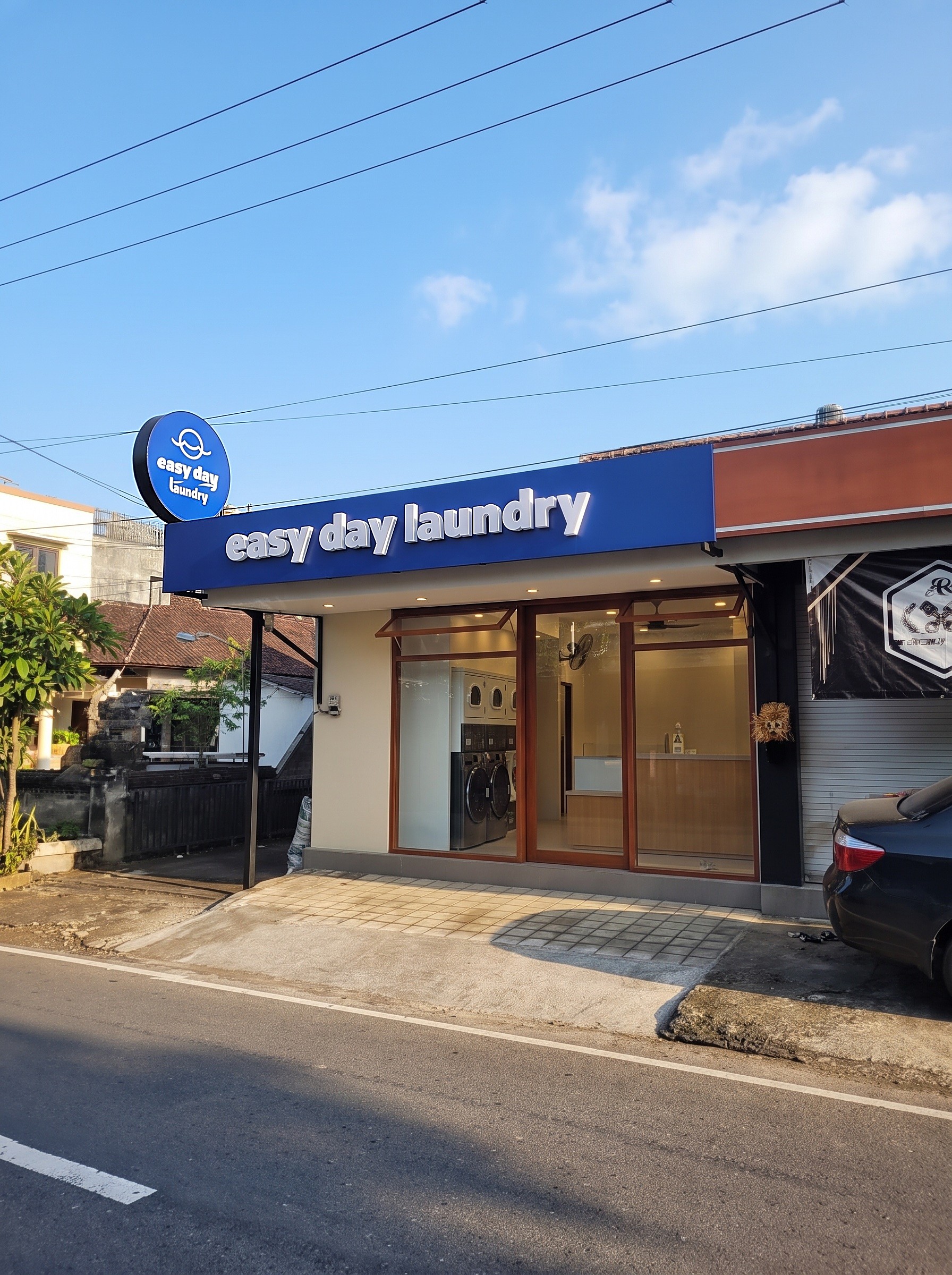 Easy Day Laundry Tumbak Bayuh storefront with blue signage